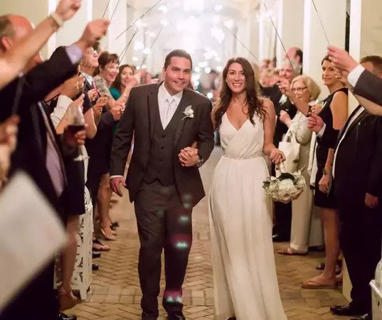 A couple walking down the aisle at their wedding.